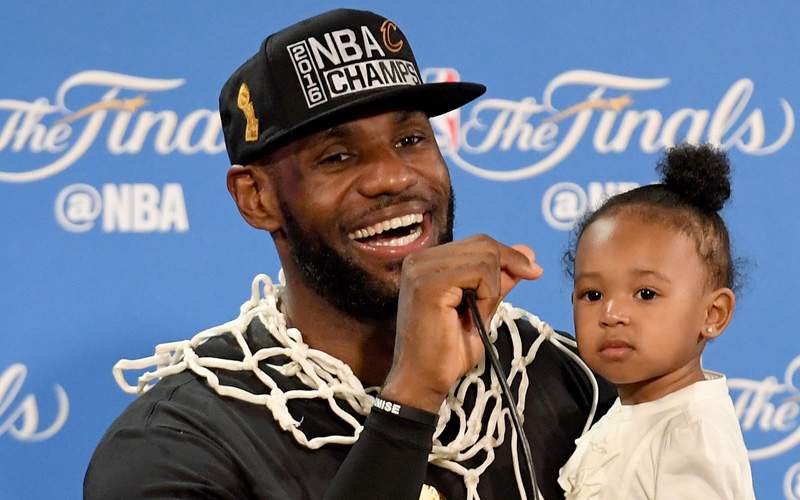 LeBron James #23 of the Cleveland Cavaliers holds his daughter during a press conference after defeating the Golden State Warriors 93-89 in Game 7 to win the 2016 NBA Finals at ORACLE Arena on June 19, 2016 in Oakland, California.