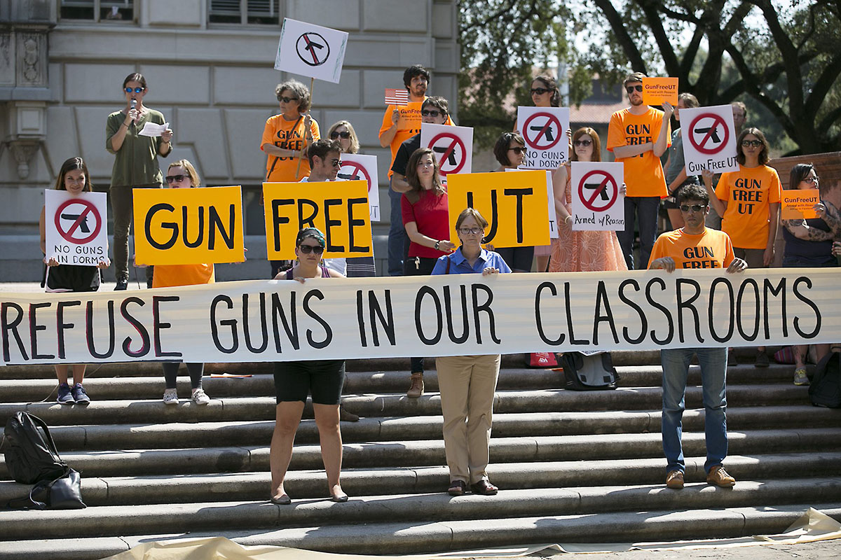 In this Oct. 1, 2015 file photo in Austin, Texas, protestors gather on the West Mall of the University of Texas campus to oppose a new state law that expands the rights of concealed handgun license holders to carry their weapons on public college campuses and as of Aug. 1, 2016, they can carry in campus buildings.