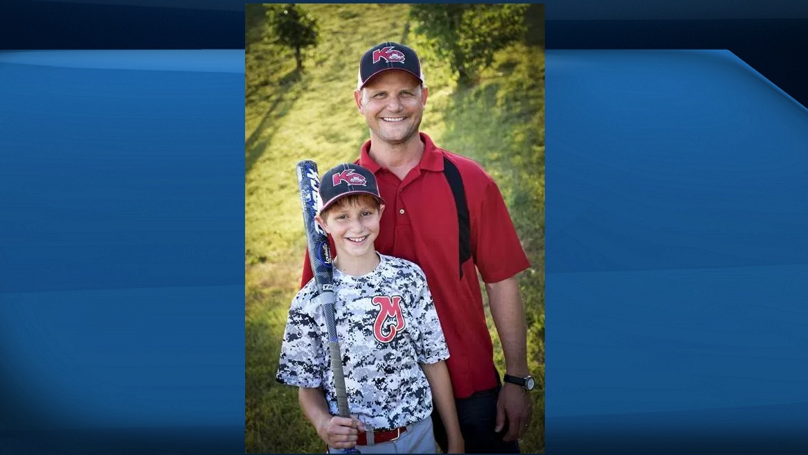 This June 2016 photo provided by David Strickland shows Caleb Thomas Schwab posing with his father Scott Schwab, a Kansas state lawmaker from Olathe. Caleb died Sunday, Aug. 7, 2016, while riding the Verruckt, a water slide that's billed as the world's largest, at the Schlitterbahn Waterpark in Kansas City, Kan.