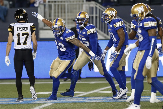 Winnipeg Blue Bombers' Justin Cole (93) celebrates his sack on Hamilton Tiger-Cats' quarterback Jeremiah Masoli (8) during the first half of CFL action in Winnipeg Wednesday, August 3, 2016.