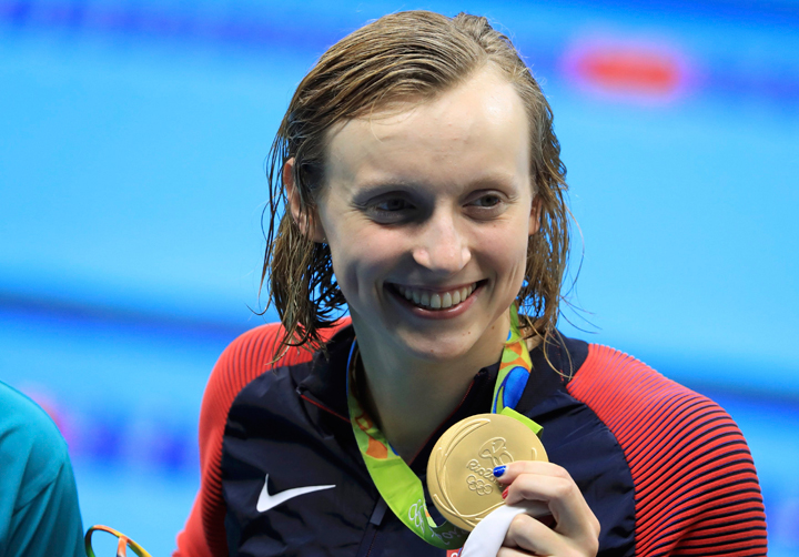 U.S. swimmer Katie Ledecky holds up her gold medal in Rio. NBC commentator Rowdy Gaines came under fire for saying "people think she swims like a man."
.