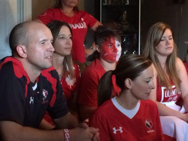Jen Kish's fiancee Nadene Selewich (second from the left) and best friend Jay Keddie-Thomson (second from the right) watch the women's rugby sevens bronze medal game.