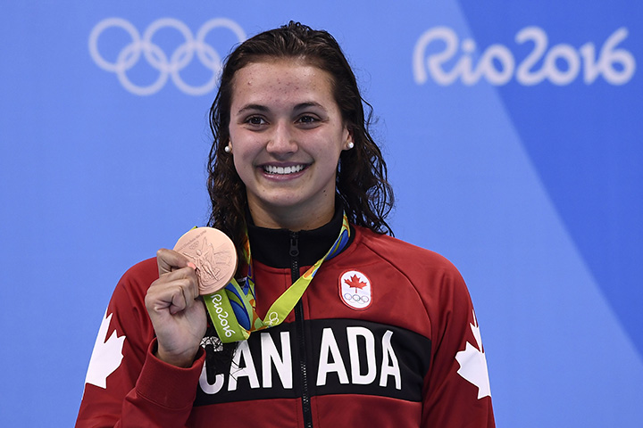 Canada's Kylie Masse poses with her bronze medal on the podium of the Women's 100m Backstroke during the swimming event at the Rio 2016 Olympic Games at the Olympic Aquatics Stadium in Rio de Janeiro on August 8, 2016.  