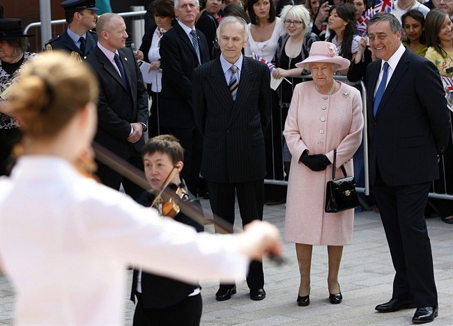 In this file photo dated Thursday May 22, 2008, Britain's Queen Elizabeth II, second right, with the Duke of Westminster, right, and Rod Holmes, third right, to watch a musical performance in Liverpool, England.