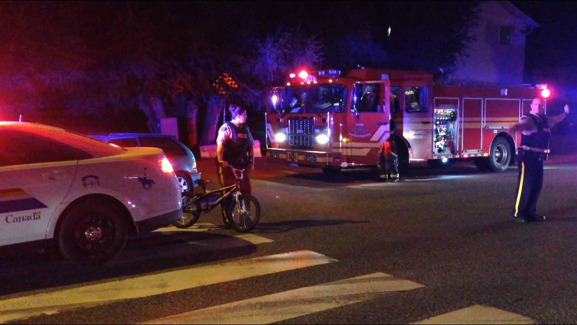 Kelowna RCMP walk a bike away from the scene of an accident that sent a girl to hospital Thursday evening.