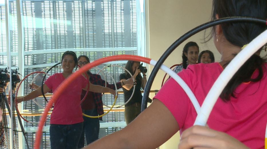 International students get a lesson in hoop dancing