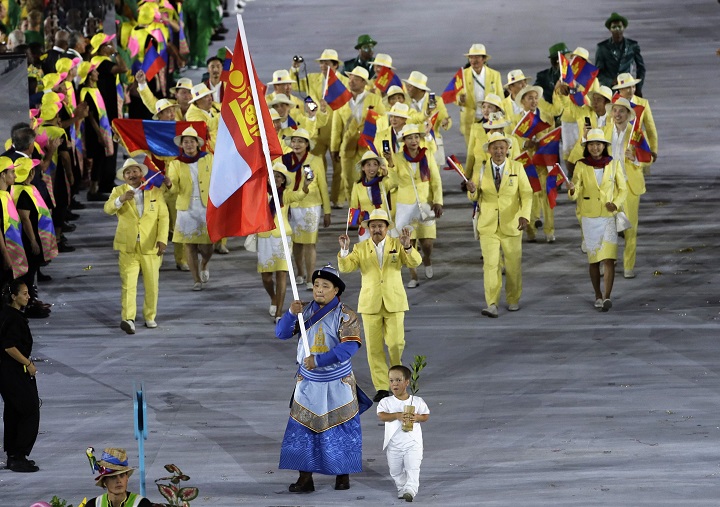Temuulen Battulga carries the flag of Mongolia during the opening ceremony for the 2016 Summer Olympics in Rio de Janeiro, Brazil, Friday, Aug. 5, 2016.