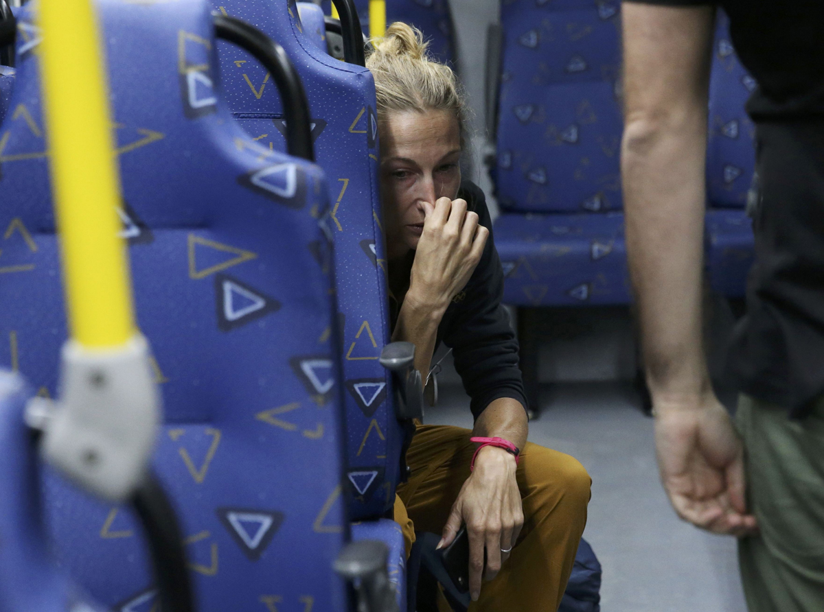 Journalist Joanna Moyse cries on an official media bus after a window shattered when driving accredited journalists to the Main Transport Mall from the Deodoro venue of the Rio 2016 Olympic Games in Rio de Janeiro, August 9, 2016. 