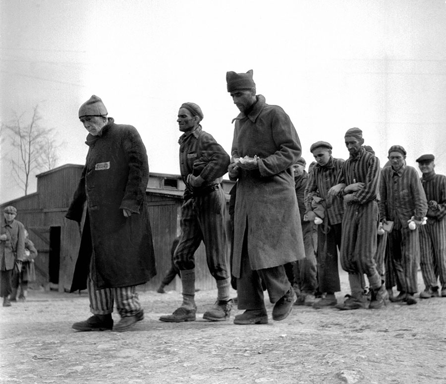 Weak and ill survivors of the Nazi concentration camp in Buchenwald march April 1945 towards the infirmary, after the liberation of the camp by Allied troops.