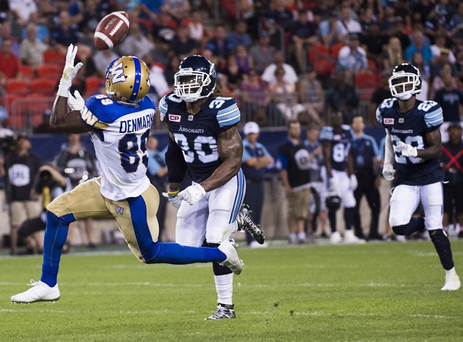 Winnipeg Blue Bombers wide receiver Clarence Denmark catches a pass in front of Toronto Argonauts defensive back Thomas Gordon before scoring a touchdown during last Friday's game.