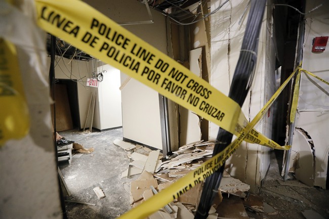 In this Tuesday, July 19, 2016, file photo, damage from a blast is shown in a hallway at El Centro College downtown campus in Dallas. 
