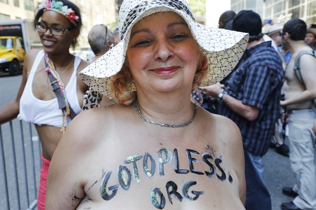 Marisse Caissy, of Montreal participates in the Go Topless Pride Parade, Sunday, Aug. 28, 2016, in New York. 