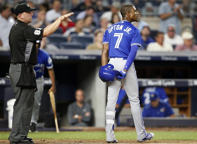 Home plate umpire Scott Barry (87) who came in for Hunter Wendelstadt after Wendelstadt left the game, signals to the pitcher after Toronto Blue Jays' Melvin Upton Jr. (7) reacts to striking out looking in a baseball game against the New York Yankees in New York, Monday, Aug. 15, 2016.