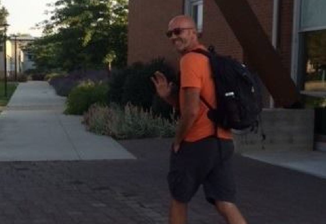 Okanagan College English professor Tim Walters setting out from the Penticton campus Tuesday morning on a fundraising walk to support an injured student.