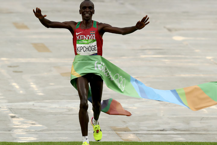 Eliud Kipchoge of Kenya celebrates as he crosses the line to win gold during the Men's Marathon on Day 16 of the Rio 2016 Olympic Games at Sambodromo.