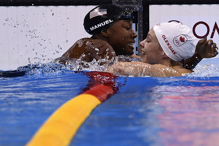 USA’s Simone Manuel and Canada’s Penny Oleksiak react after they equally won the women’s 100m freestyle final during the swimming event at the Rio 2016 Olympic Games at the Olympic Aquatics Stadium in Rio de Janeiro on August 11, 2016.