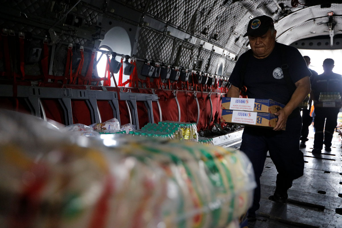 Members of Peru's National Institute of Civil Defense and Peru's Air Force load a cargo plane with aid to be delivered to the Caylloma province of the Andean region Arequipa after a 5.3 magnitude shallow earthquake rocked the region, in Lima, Peru, August 15, 2016.