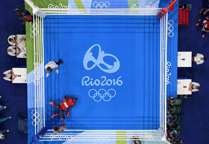 Julio Cesar La Cruz of Cuba falls during his bout with Adilbek Niyazymbetov of Kazakhstan in the men’s 81kg final.