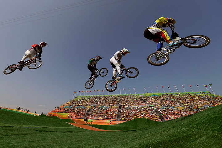 Cyclists, from right, Jefferson Milano of Venezuela, Luis Brethauer of Germany, Kyle Dodd of South Africa and David Graf of Switzerland compete in the BMX cycling quarterfinals during the 2016 Summer Olympics in Rio de Janeiro, Brazil, Thursday, Aug. 18, 2016.