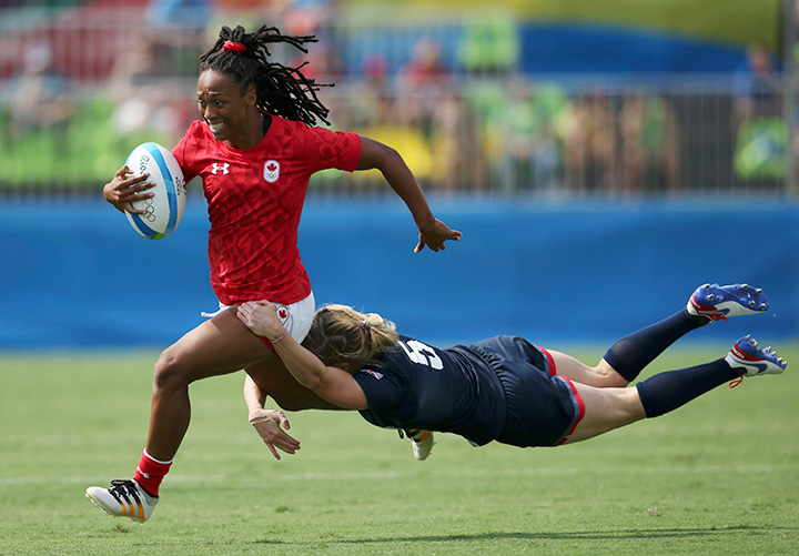 Canada’s Charity Williams is tackled by Danielle Waterman of the U.K. during women’s pool C rugby action on August 7, 2016 in Rio de Janeiro, Brazil.    
