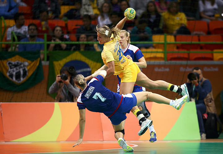Daria Dmitrieva of Russia and Isabelle Gullden of Sweden in action during preliminary Group B handball competition.  