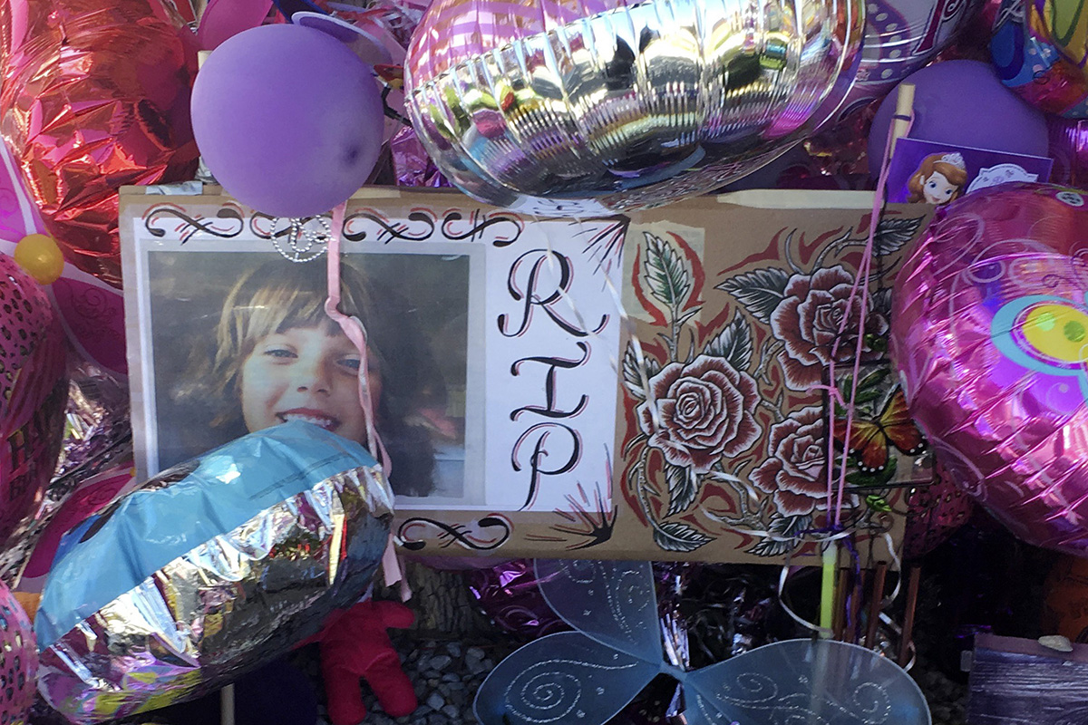 A picture of Victoria Martens, a 10-year-old Albuquerque girl brutally murdered last week, is placed in a memorial outside her former Albuquerque apartment on Monday, Aug. 29, 2016. 