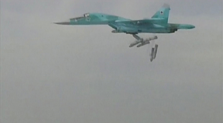 A still image, taken from video and released by Russia's Defence Ministry, shows a Russian Sukhoi Su-34 fighter-bomber based at Iran's Hamadan air base dropping bombs in Syria.  