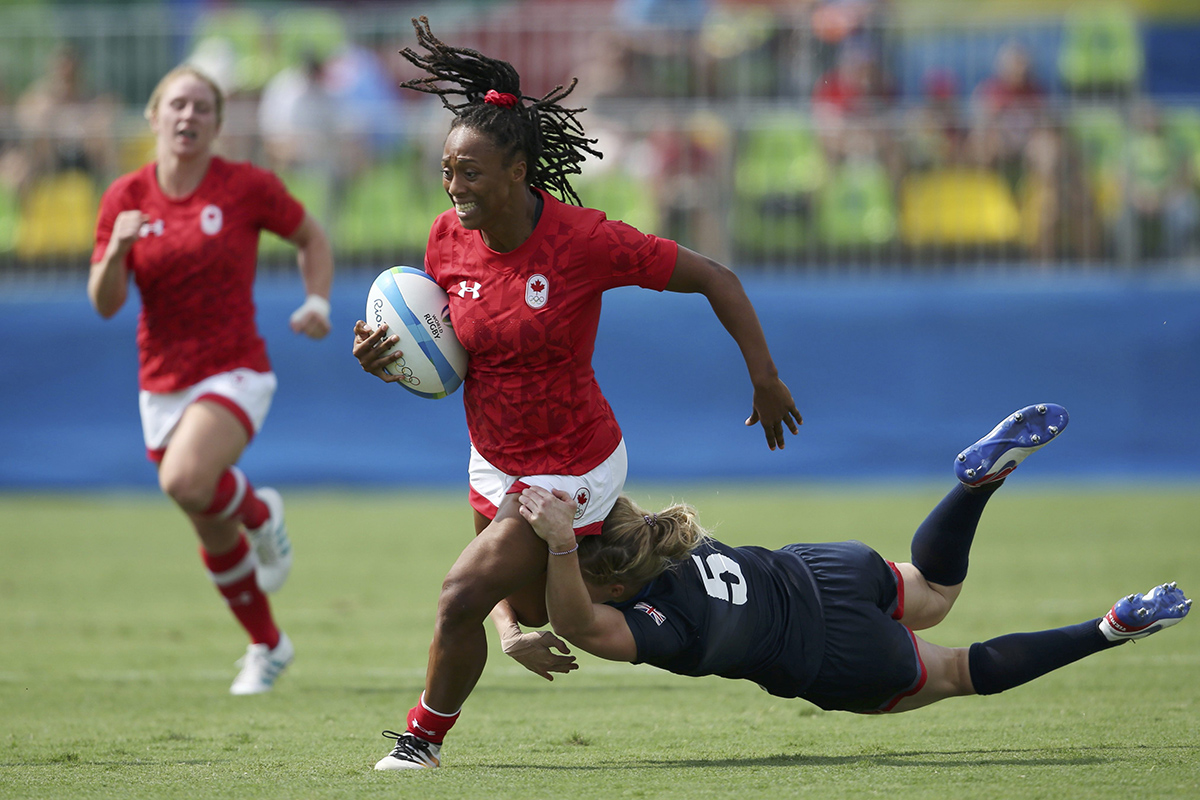 Charity Williams of Canada is tackled by Danielle Waterman of United Kingdom. 
