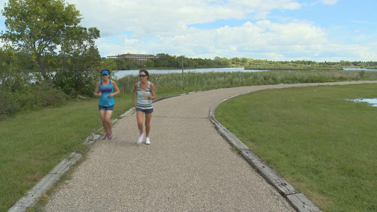 Two runners enjoy the path that surrounds Wascana Lake.