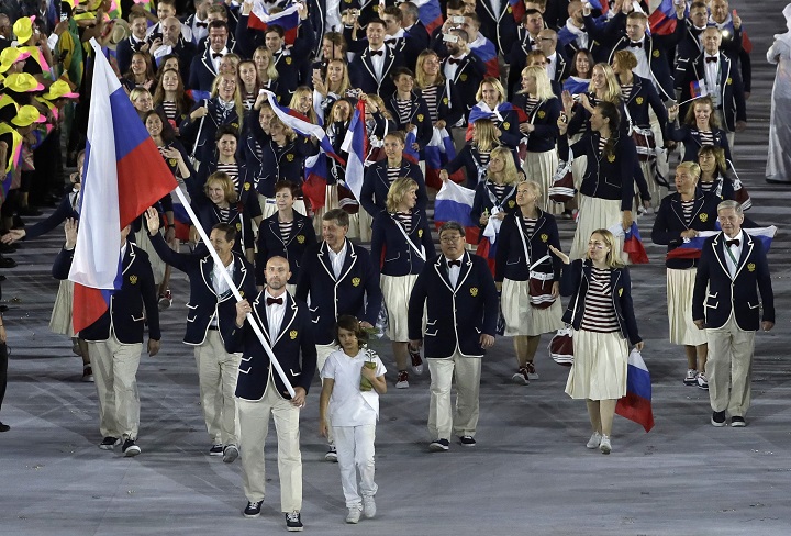 Sergei Tetiukhin carries the flag of Russia during the opening ceremony for the 2016 Summer Olympics in Rio de Janeiro, Brazil, Friday, Aug. 5, 2016.