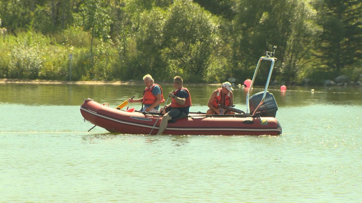 A team of searchers head out on the water at Birds Hill Provincial Park.