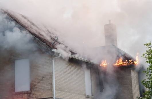 Fire fighters arrive on the scene of a house fire at Selkirk Avenue Sunday morning.