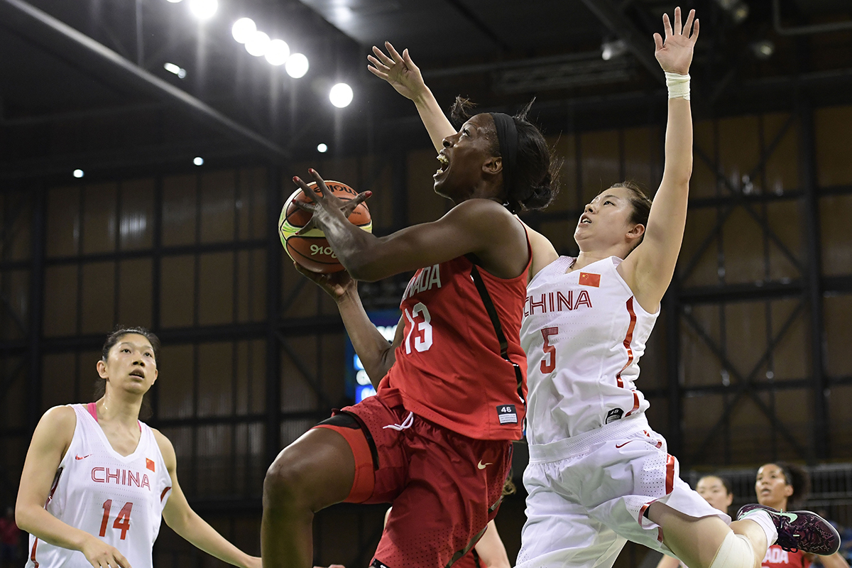 Canada's forward Tamara Tatham (C) jumps for a basket by China's guard Chen Xiaojia during a Women's round Group A basketball match between China and Canada at the Youth Arena in Rio de Janeiro on August 6, 2016 during the Rio 2016 Olympic Games.