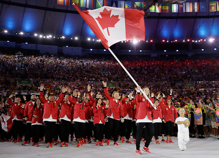 Canada’s Rosie MacLennan carries the flag during the opening ceremony for the 2016 Summer Olympics in Rio de Janeiro, Brazil, Friday, Aug. 5, 2016.