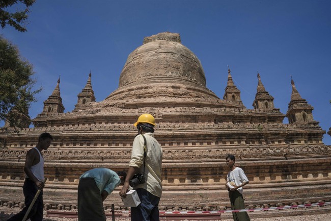 Workers set the security line around the earthquake-damaged Sitanagyi Pagoda in Bagan, Myanmar, Thursday, Aug. 25, 2016.