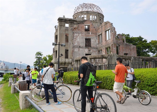 In this July 26, 2016 file photo, people play Pokemon Go near the Atomic Bomb Dome at Hiroshima Peace Memorial Park in Hiroshima, Japan. The atomic bomb memorial park in Hiroshima is now Pokemon-free.