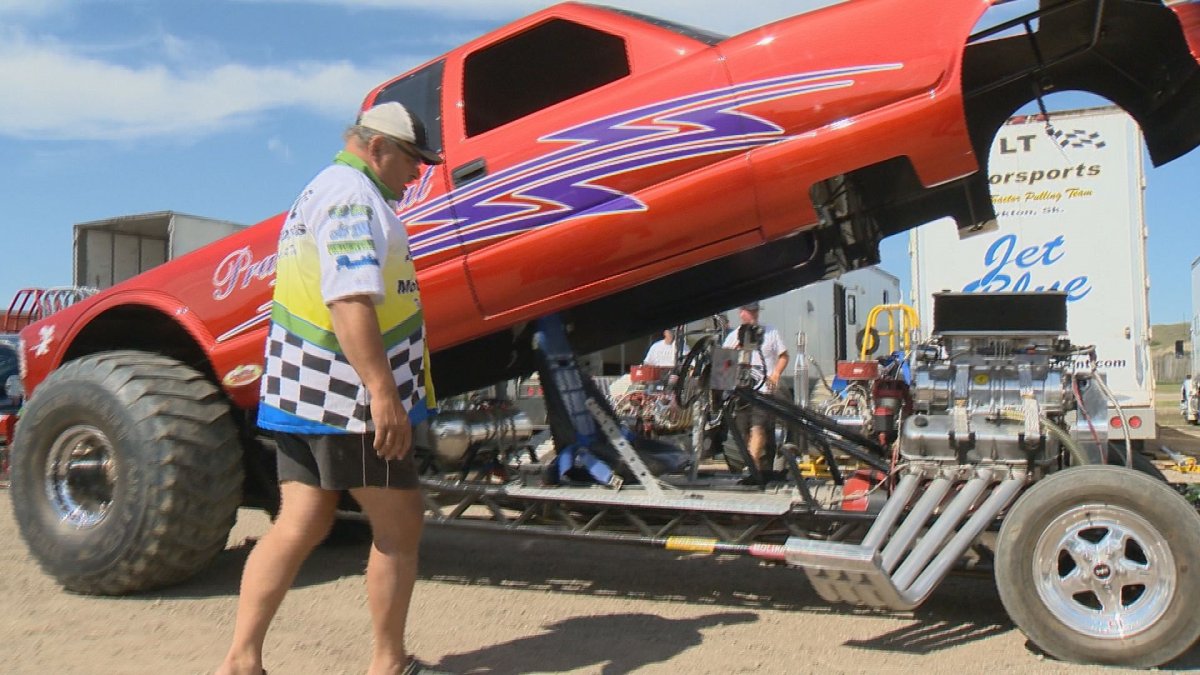 Larry Hilworth examines one of his eight modified trucks/tractors at the first annual Canadian Truck Fest in Craven, Sask.