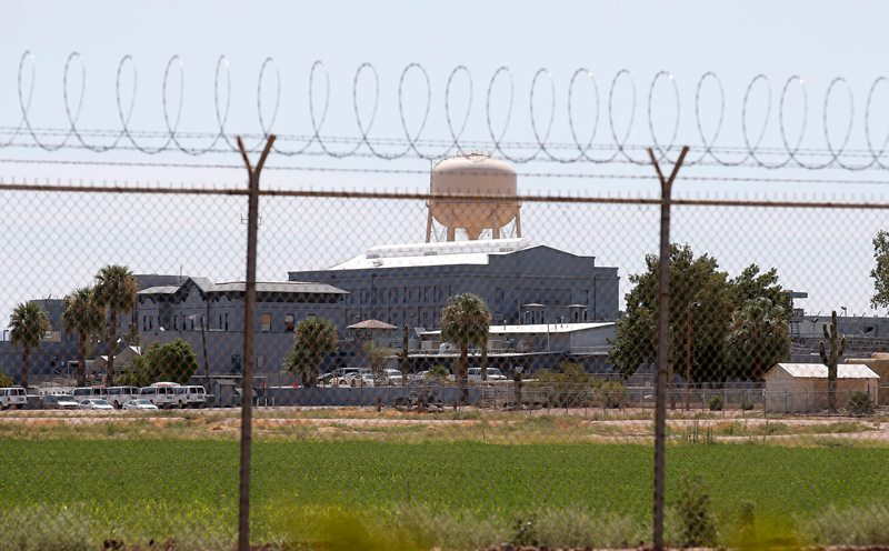 In this July 23, 2014, file photo, a fence surrounds the state prison in Florence, Ariz.