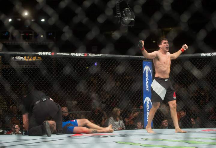 Demian Maia, right, of Brazil, celebrates after defeating Carlos Condit, of Albuquerque, N.M., during a welterweight bout during a UFC Fight Night event in Vancouver on Saturday, August 27, 2016.