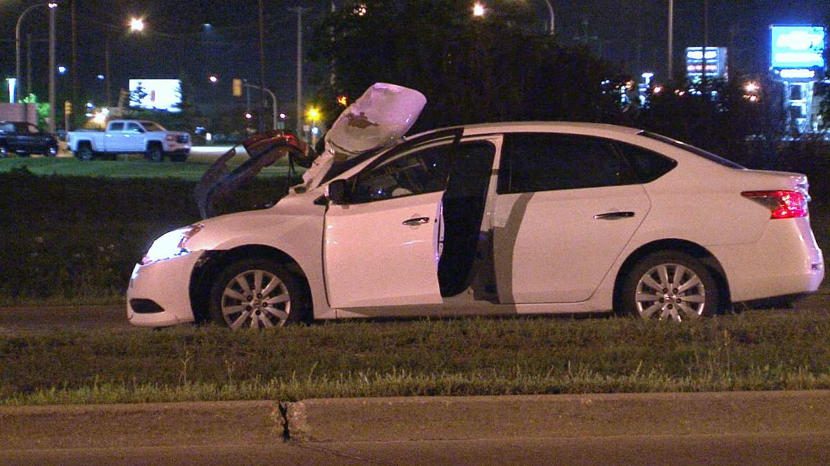 A damaged car sits parked at the scene where an adult female was hit and killed by a vehicle Sunday morning. 