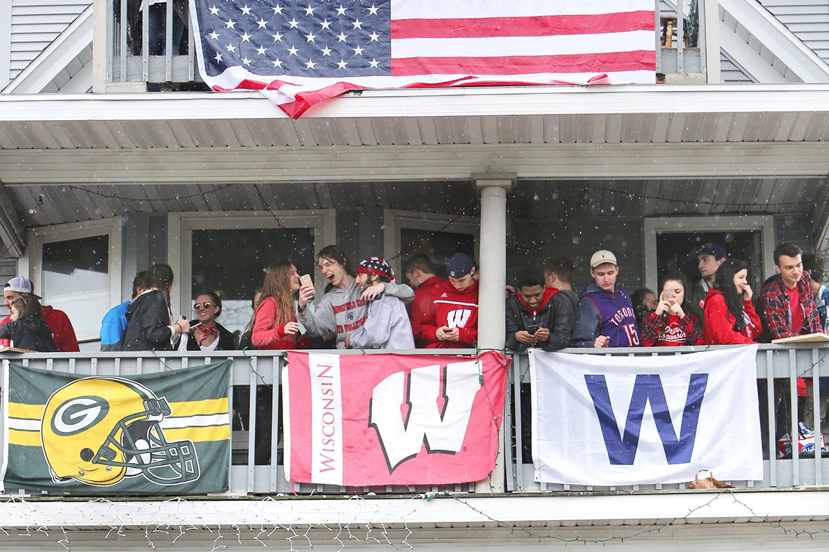 In this April 30, 2016, photo, people stand on porches and balconies at a home on Mifflin Street during the annual block party in Madison, Wis. 