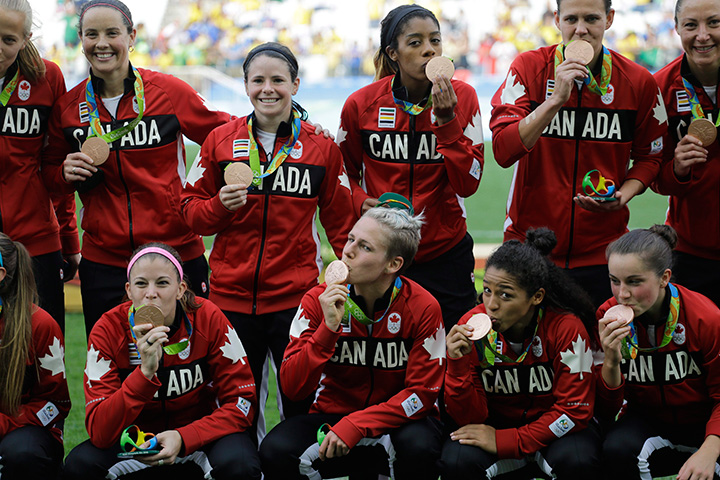 Team Canada poses for photos after winning the bronze medal in the women's Olympic football tournament between Brazil and Canada at the Arena Corinthians stadium in Sao Paulo, Friday Aug. 19, 2016. 
