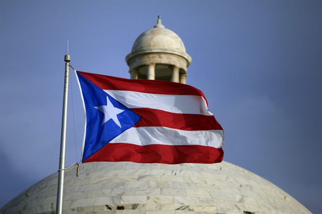 The Puerto Rican flag flies in front of Puerto Rico's Capitol in San Juan, Puerto Rico, in this July 29, 2015 file photo.