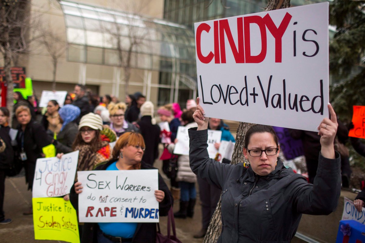 Protesters hold signs outside Edmonton's city hall on Thursday, April 2, 2015 in support of Cindy Gladue, the 36-year-old woman who bled to death in an Edmonton motel room. 