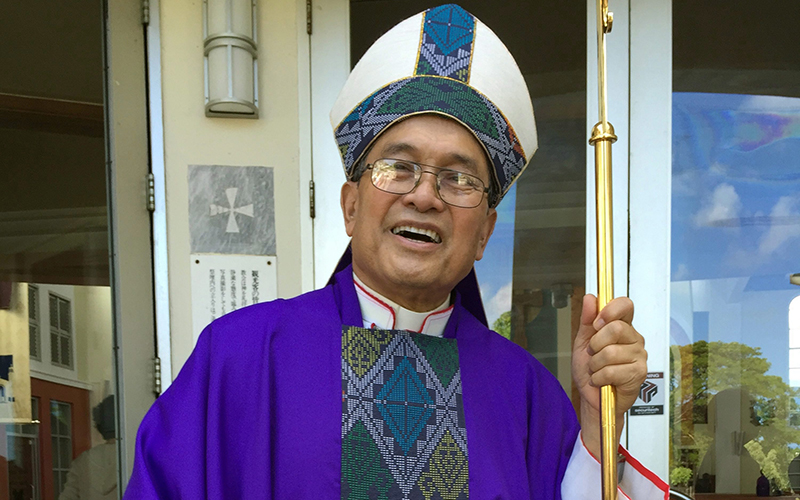 This November 2014 photo shows Archbishop Anthony Apuron standing in front of the Dulce Nombre de Maria Cathedral Basilica in Hagatna, Guam. 