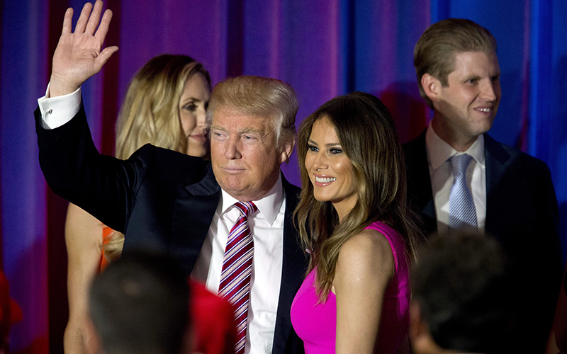 Republican presidential candidate Donald Trump waves at supporters as he leaves the stage with his wife Melania after a news conference at the Trump National Golf Club Westchester in Briarcliff Manor, N.Y. 