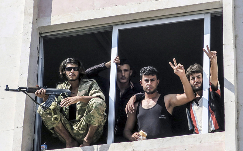 Free Syrian Army fighters gesture in Jarablus, Syria, Wednesday, Aug. 31, 2016. 