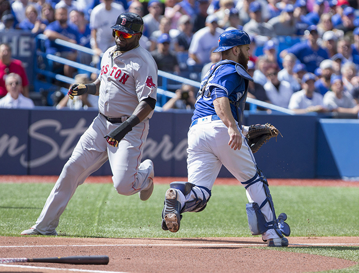 Boston Red Sox designated hitter David Ortiz (34) heads to home plate past Toronto Blue Jays catcher Russell Martin (55) during first inning American League baseball action in Toronto on Sunday.