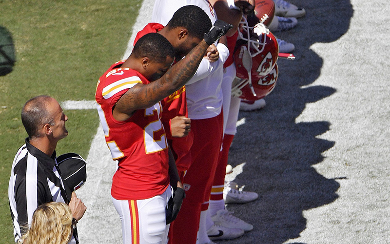 Kansas City Chiefs cornerback Marcus Peters raises his fist in the air during the national anthem before an NFL football game against the San Diego Chargers on Sunday, Sept. 11, 2016, in Kansas City, Mo. 