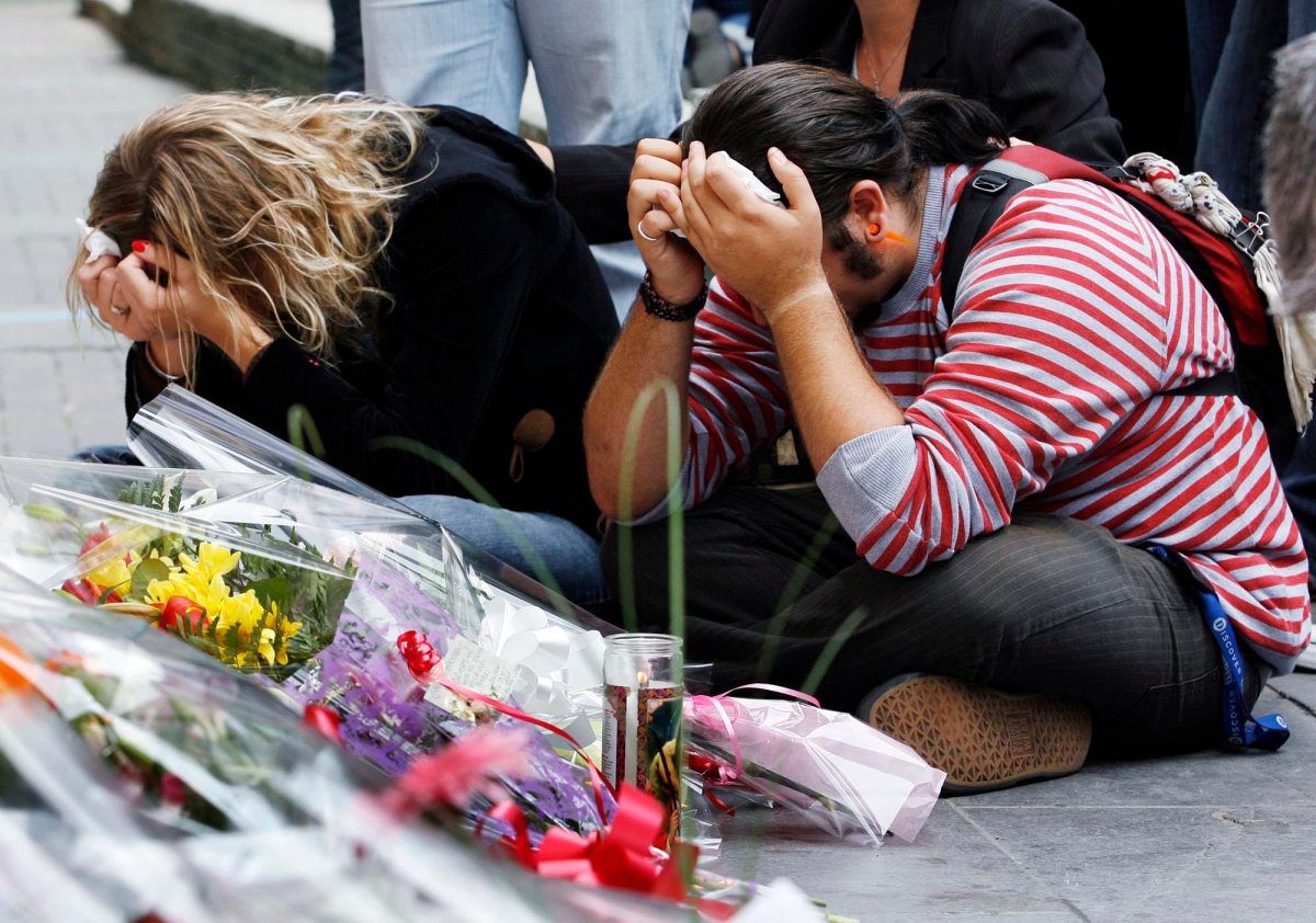 Students are overcome with emotion at a makeshift memorial in front of Dawson College in Montreal Friday, Sept. 15, 2006. A gunman killed one student Wednesday and wounded twenty others before killing himself.